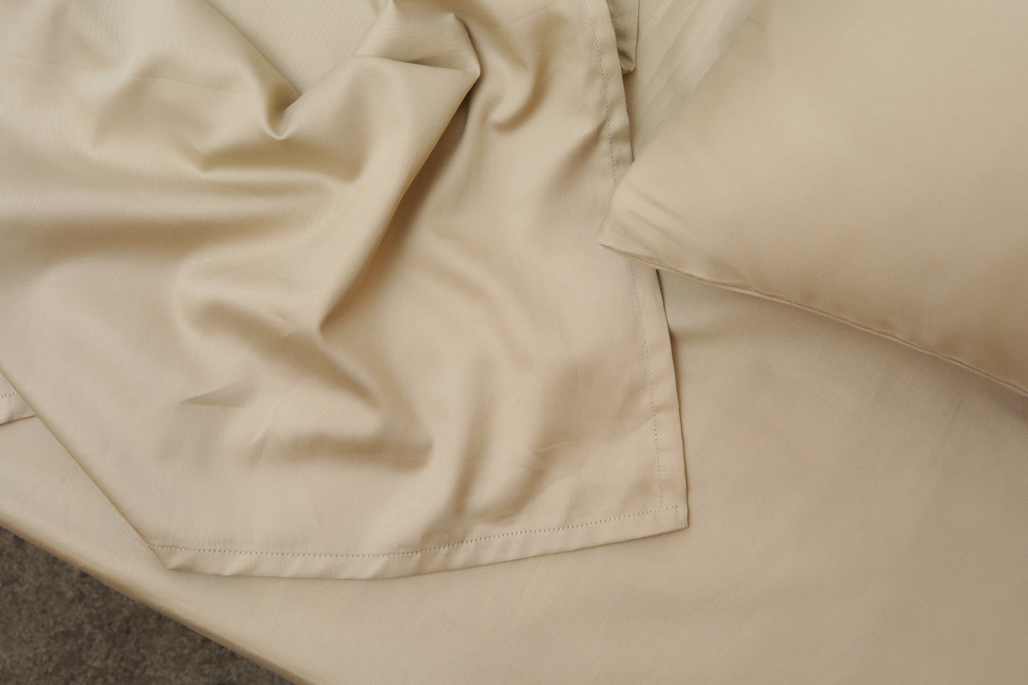Greige cream bed sheets set with neat stitching and corner detail