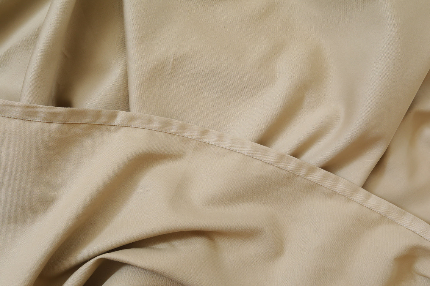 Close-up of greige cream fitted sheet soft cotton fabric