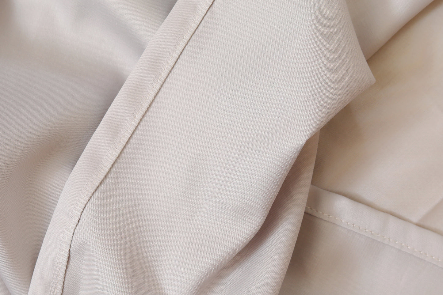 Close-up of light grey fitted sheet soft fabric texture