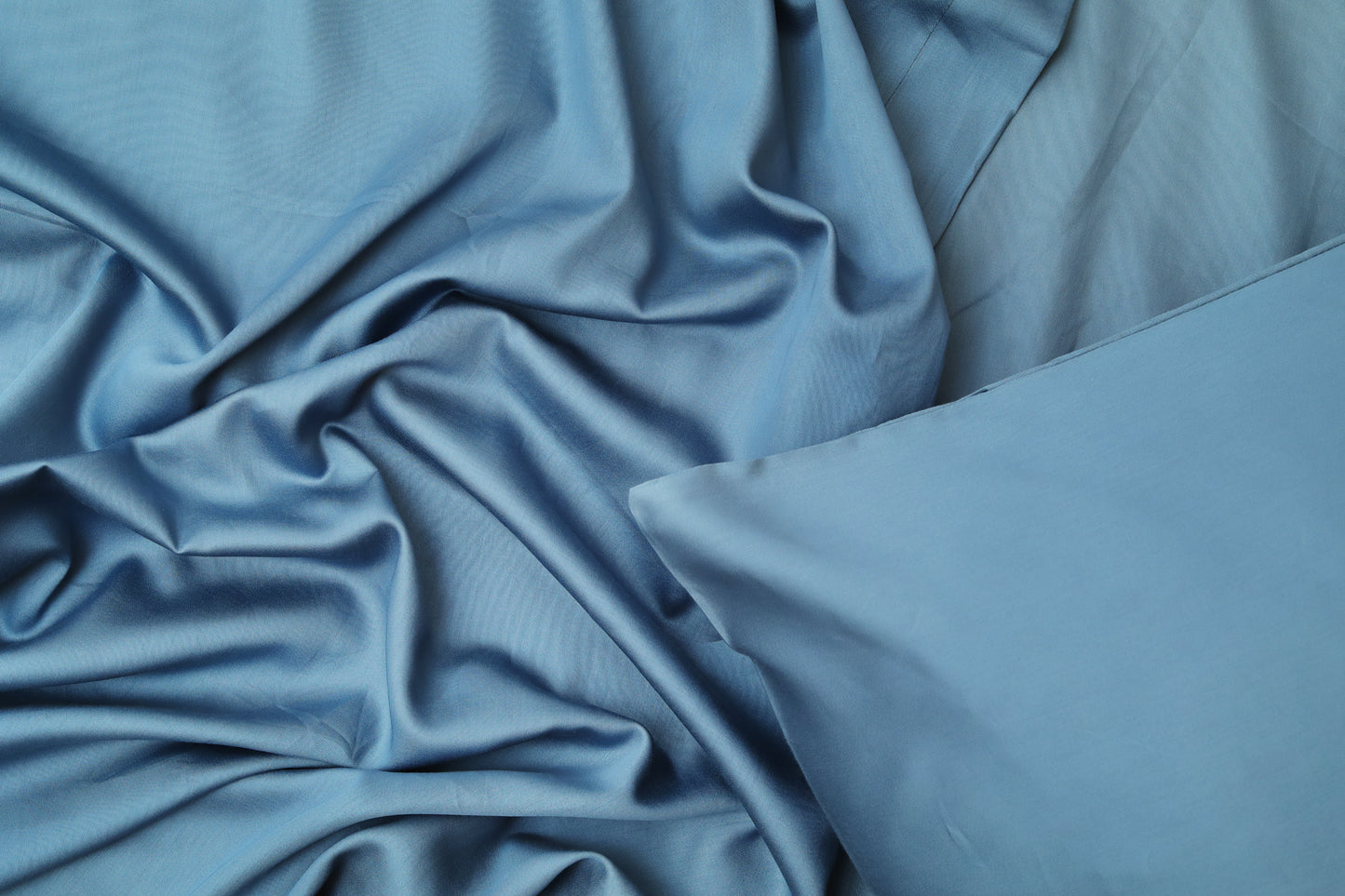 Close-up of midnight blue fitted sheet smooth cotton fabric