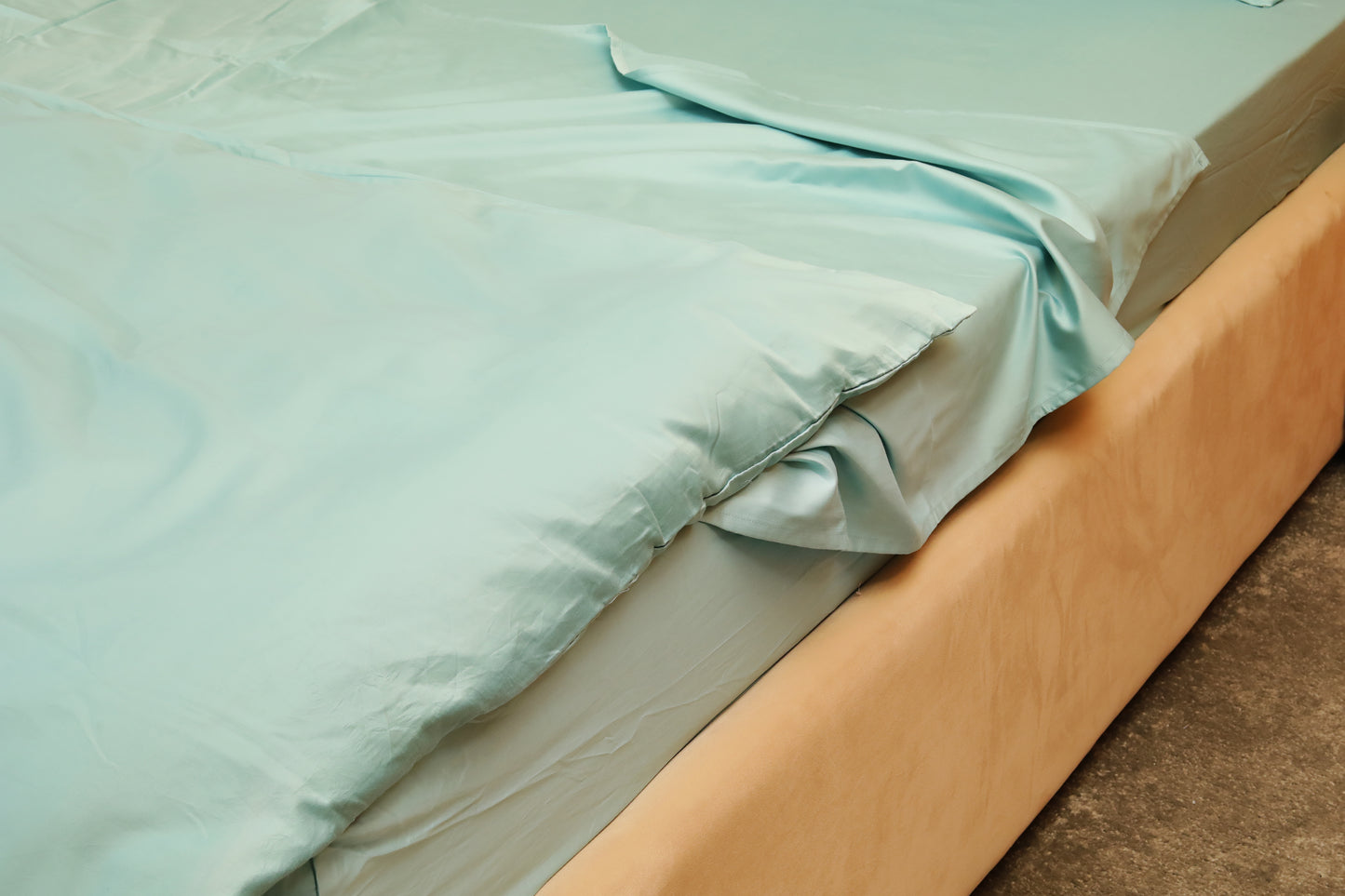 Sky blue bed sheets set neatly spread on mattress