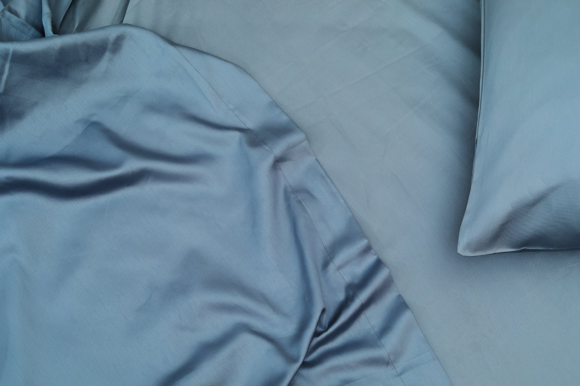 Midnight blue bed sheets set neatly spread with pillow cover