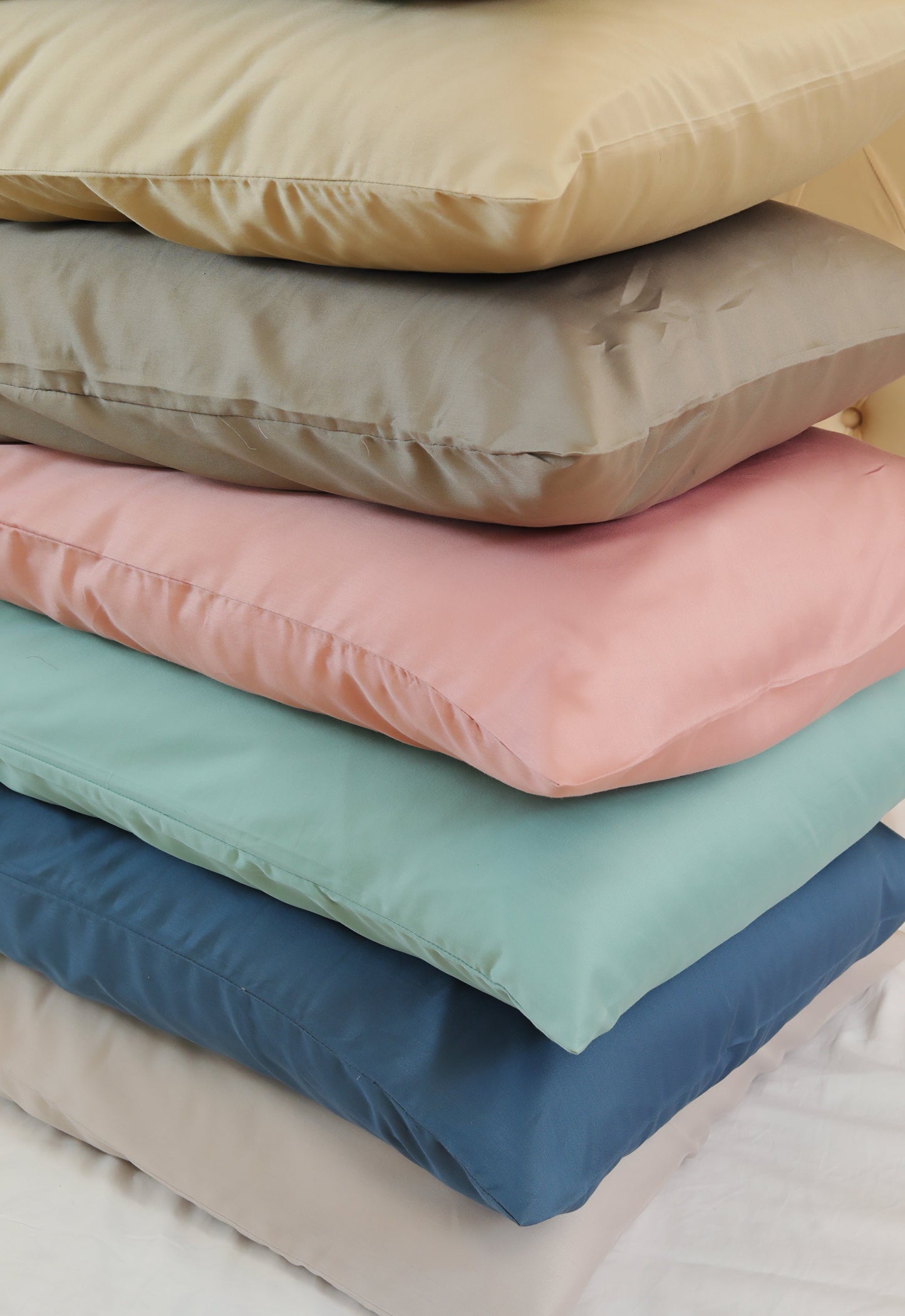 Stacked pillowcase pairs in multiple solid colors