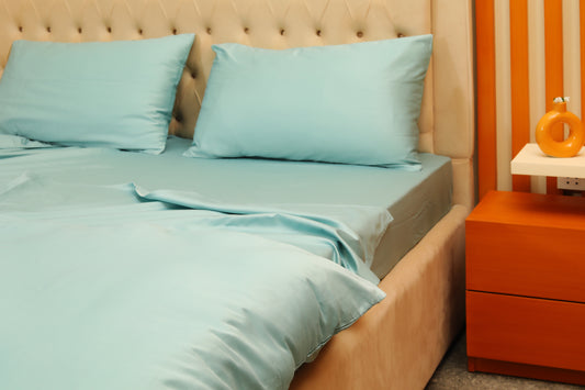 Sky blue bed sheets set with matching pillowcases on bed